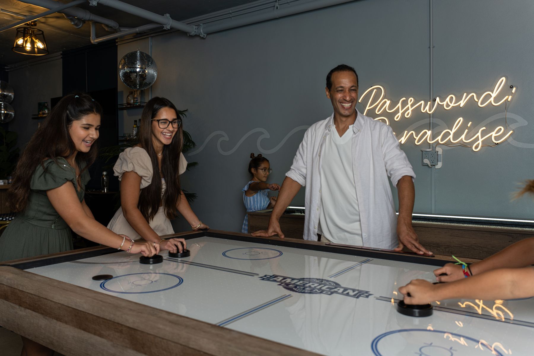 turtle cove airbnb people playing air hockey
